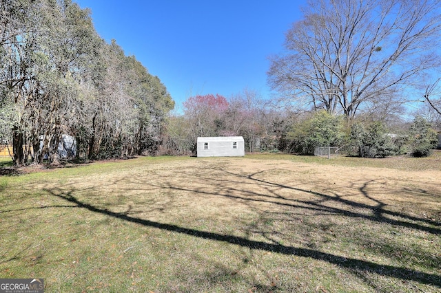 view of yard featuring an outbuilding and a shed