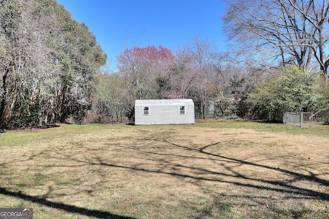 view of yard with an outdoor structure and fence