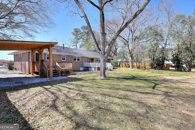 view of yard featuring a carport and a deck