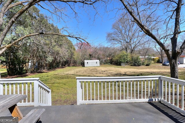 view of patio / terrace featuring a storage unit and an outdoor structure