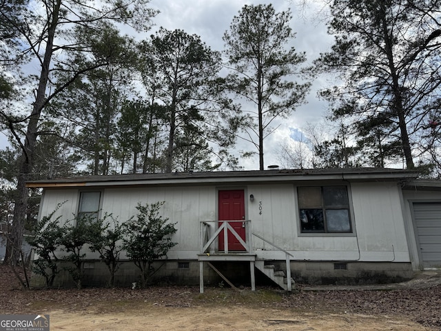 view of front facade featuring crawl space, an attached garage, and entry steps