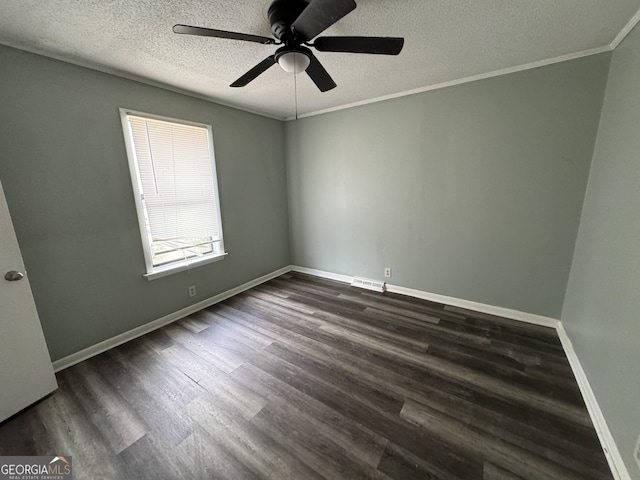 spare room featuring visible vents, baseboards, ornamental molding, a textured ceiling, and dark wood-style flooring