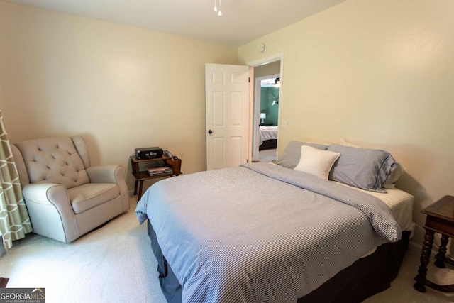 bedroom featuring light carpet