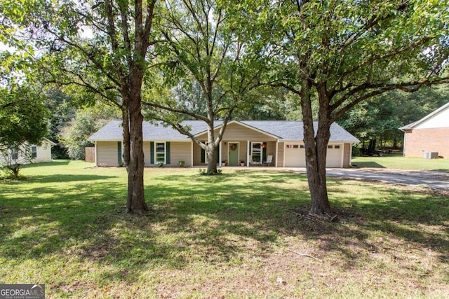 ranch-style house featuring a front yard, a garage, and driveway