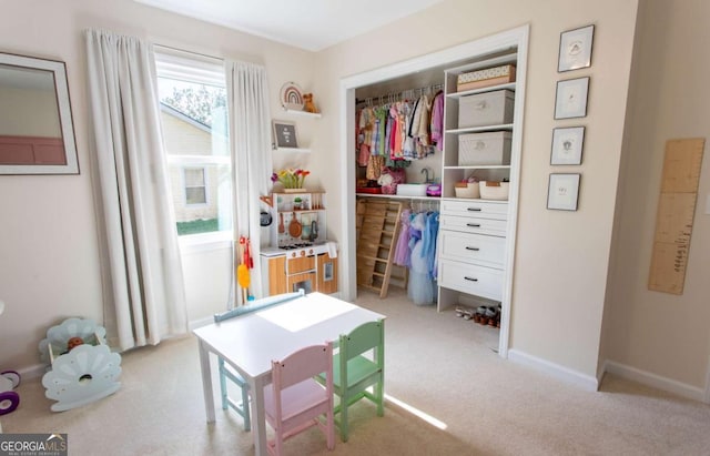 interior space featuring light colored carpet and baseboards