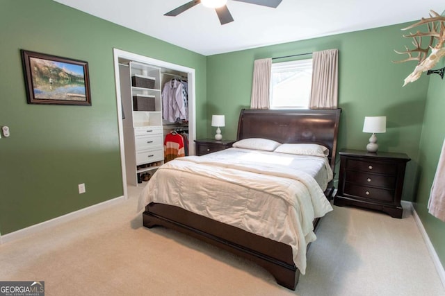 carpeted bedroom featuring a closet, a ceiling fan, and baseboards