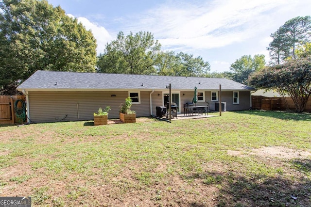 back of property featuring a lawn, a fenced backyard, and a patio area