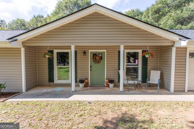 view of front of home with covered porch and roof with shingles