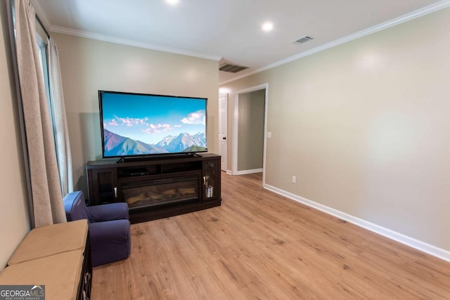 interior space featuring visible vents, baseboards, wood finished floors, and ornamental molding