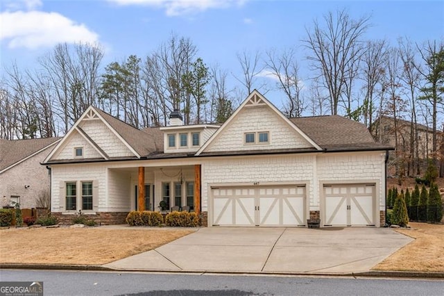 view of front of house featuring a porch, an attached garage, a chimney, and driveway