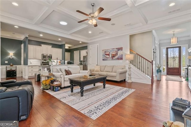 living area with stairs, hardwood / wood-style flooring, visible vents, and coffered ceiling