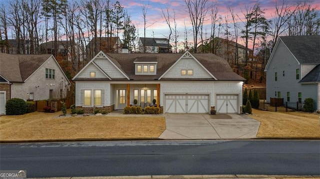 view of front facade featuring a garage, driveway, and fence