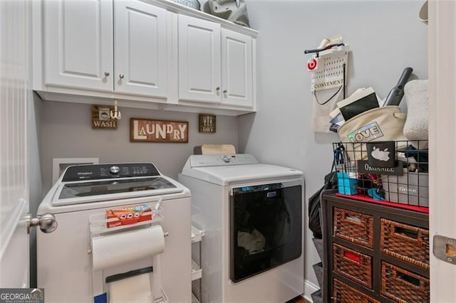 laundry area with washer and clothes dryer and cabinet space