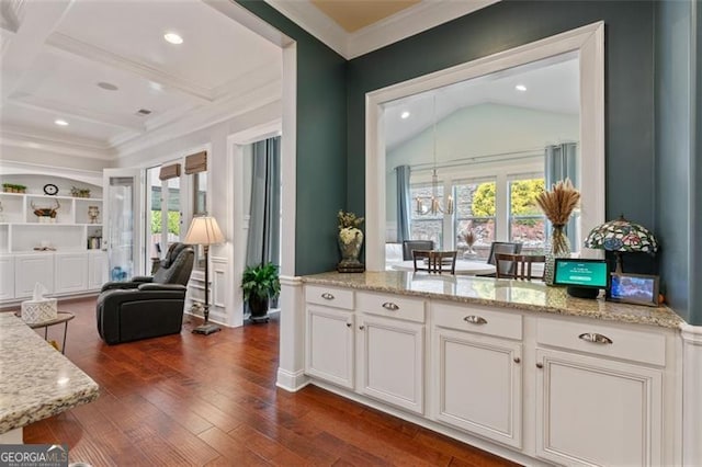 kitchen featuring a healthy amount of sunlight, dark wood-style floors, white cabinets, and ornamental molding