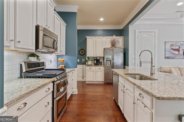 kitchen featuring visible vents, ornamental molding, stainless steel appliances, and a sink