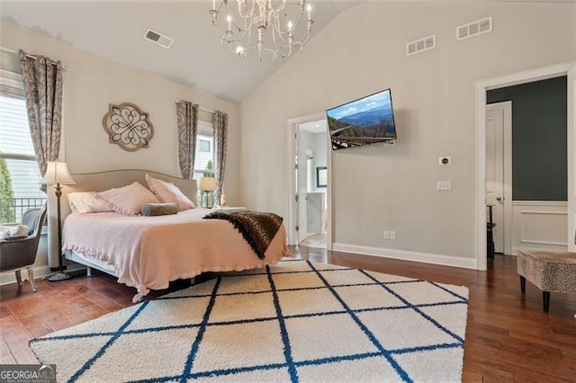 bedroom with a notable chandelier, visible vents, and wood finished floors