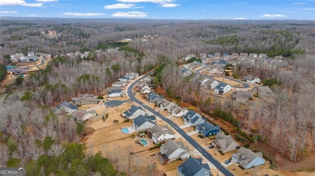 drone / aerial view with a wooded view