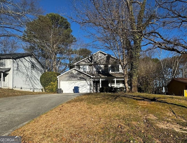 view of front of house featuring a garage, a front yard, and driveway