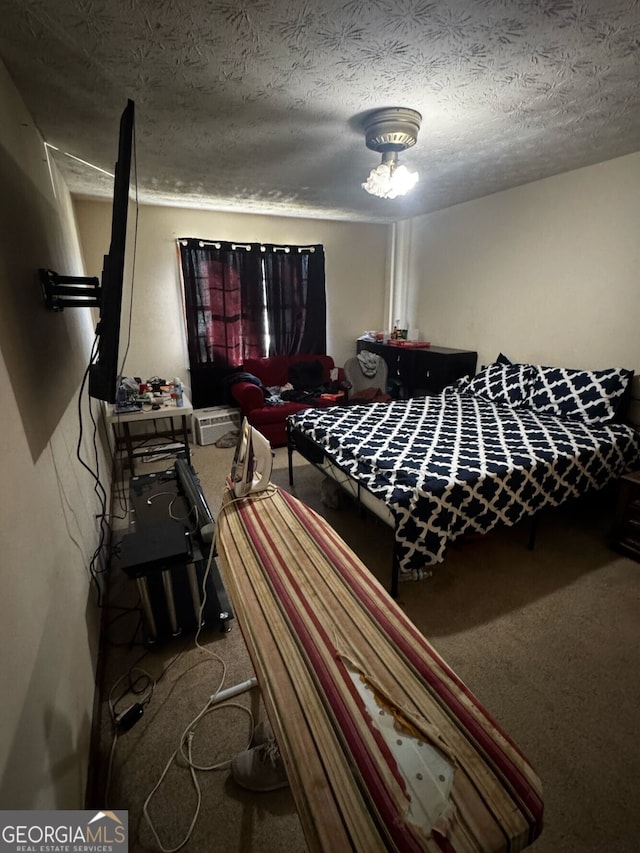 bedroom featuring a textured ceiling and carpet