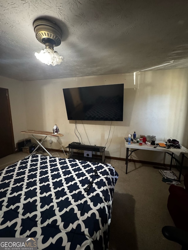 carpeted bedroom featuring a textured ceiling