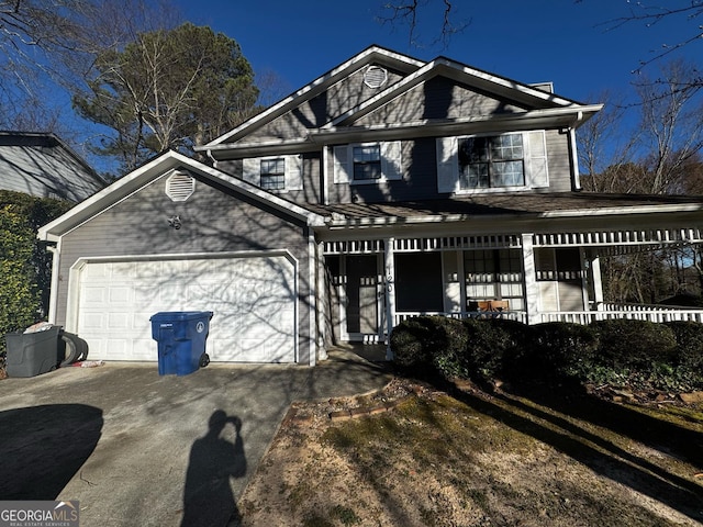 view of front facade featuring a garage, covered porch, and concrete driveway