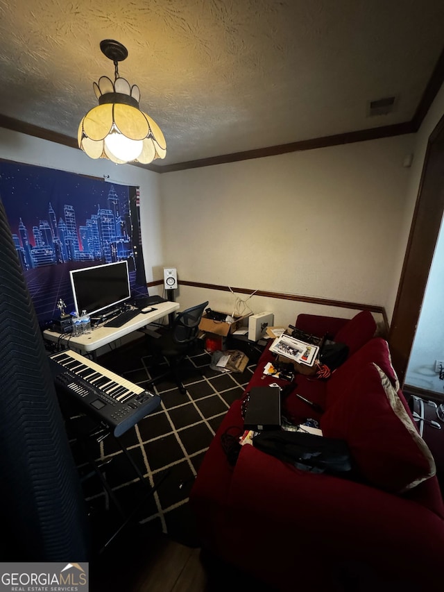 home office with visible vents, a textured ceiling, and crown molding