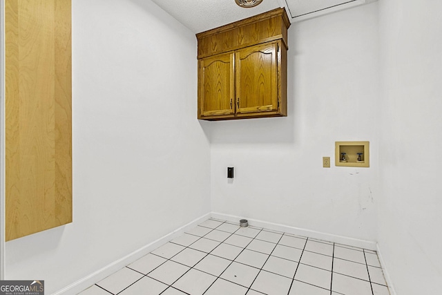 laundry room featuring hookup for a washing machine, light tile patterned floors, baseboards, cabinet space, and electric dryer hookup