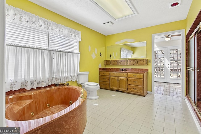 full bathroom with tile patterned floors, toilet, a jetted tub, french doors, and vanity