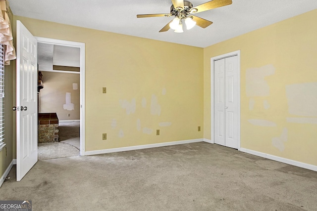 unfurnished bedroom featuring baseboards, carpet, and ceiling fan