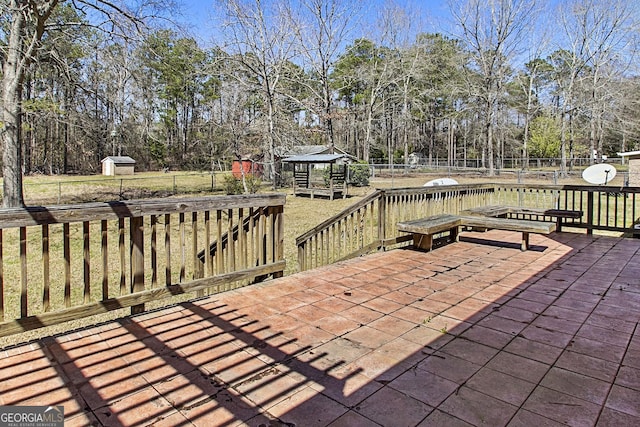 view of patio with an outbuilding, a shed, and a fenced backyard