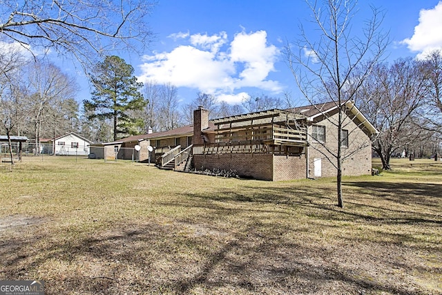 view of property exterior featuring a lawn, brick siding, and a chimney