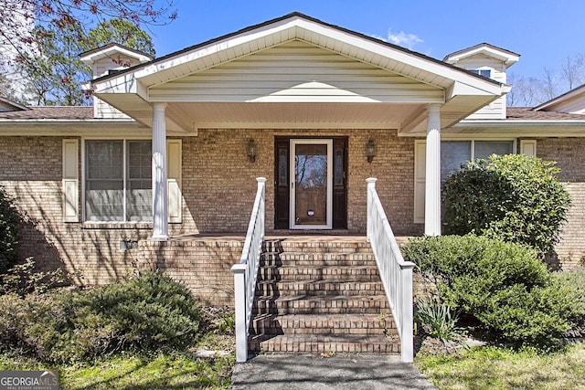 entrance to property featuring brick siding