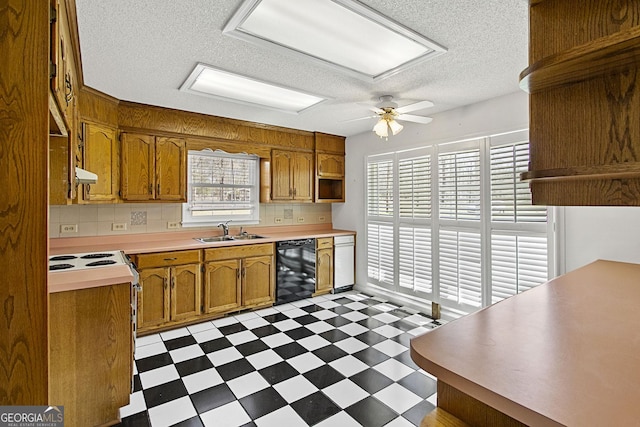 kitchen with tile patterned floors, white appliances, a healthy amount of sunlight, and a sink