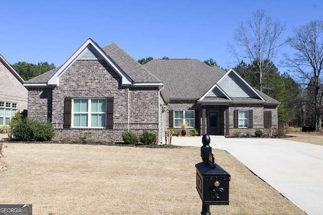 craftsman-style home featuring brick siding and roof with shingles