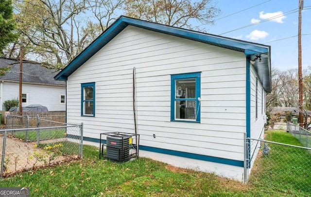 view of property exterior with a yard and fence