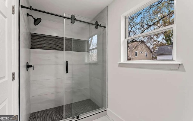 full bath with baseboards and a stall shower