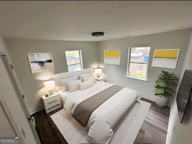 bedroom featuring baseboards and wood finished floors