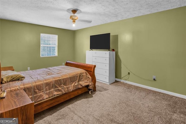 carpeted bedroom with ceiling fan, a textured ceiling, and baseboards