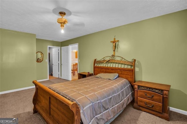 bedroom with carpet flooring, a ceiling fan, ensuite bathroom, and baseboards