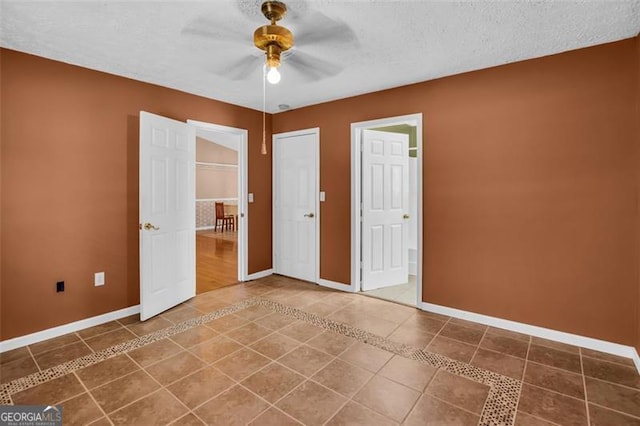 unfurnished bedroom featuring baseboards, a textured ceiling, ceiling fan, and tile patterned flooring