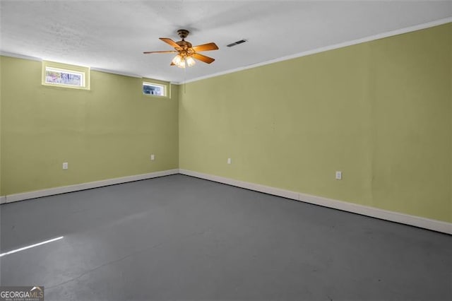 spare room with visible vents, concrete flooring, and baseboards