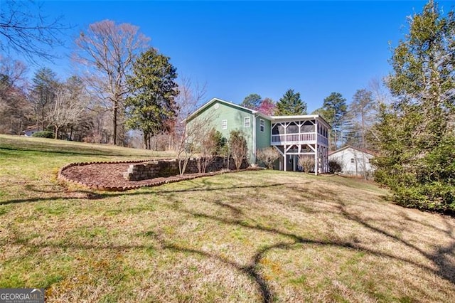 rear view of property with a lawn and a sunroom