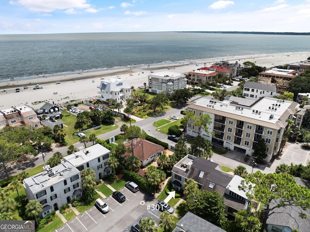 drone / aerial view featuring a beach view and a water view