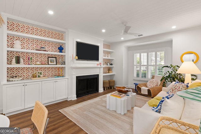 living area with recessed lighting, built in features, a fireplace, and dark wood-style flooring