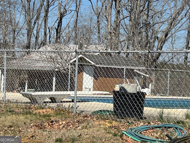 exterior space with an outdoor structure and fence