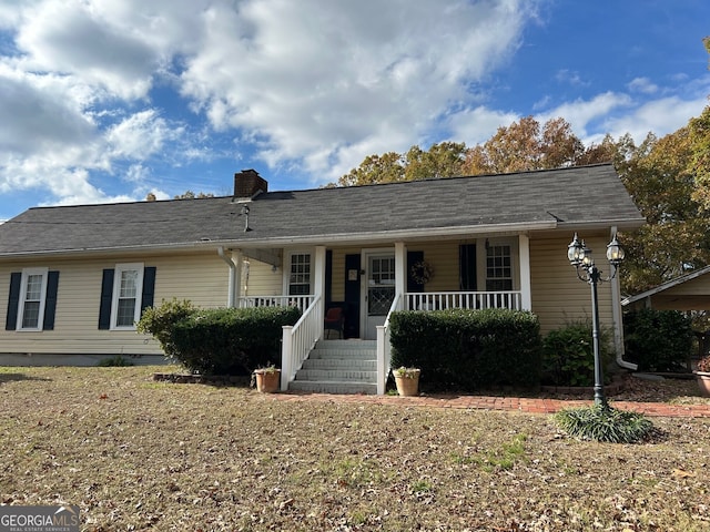 single story home featuring a porch and a chimney