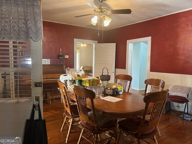 dining space featuring ceiling fan, a textured ceiling, hardwood / wood-style floors, and ornamental molding