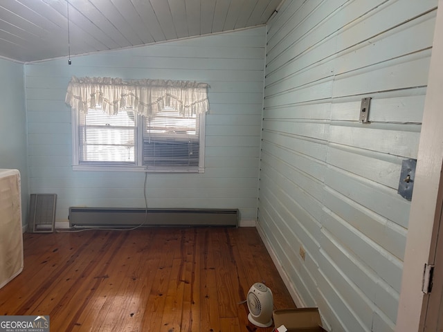 unfurnished room with baseboard heating, hardwood / wood-style floors, and wooden ceiling