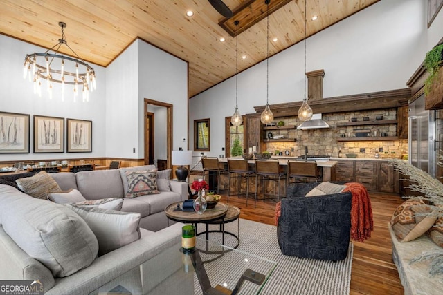 living area featuring recessed lighting, wood ceiling, a high ceiling, and wood finished floors