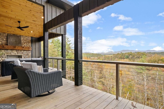 deck with a mountain view and ceiling fan